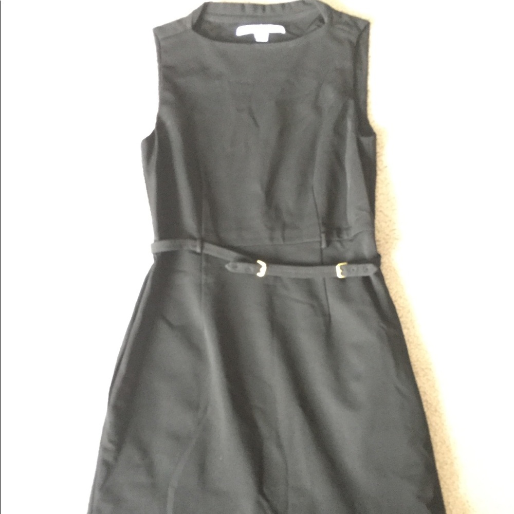 A black knee length dress with gold belt